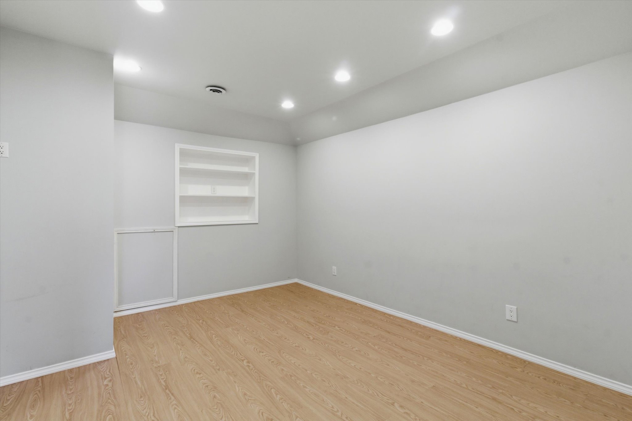 1511 Rimstone Drive Cedar Park, TX 78613 - Photo 25 of 39 Recessed lighting illuminates this versatile room with built-in shelving and durable wood flooring.