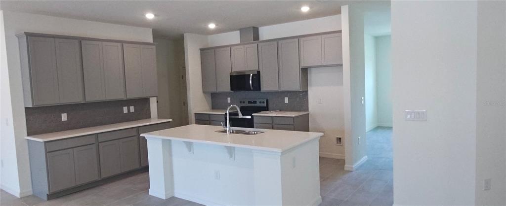 51 Kankakee Trail Palm Coast, FL 32164 - Photo 2 of 14 a kitchen with a sink a stove and refrigerator