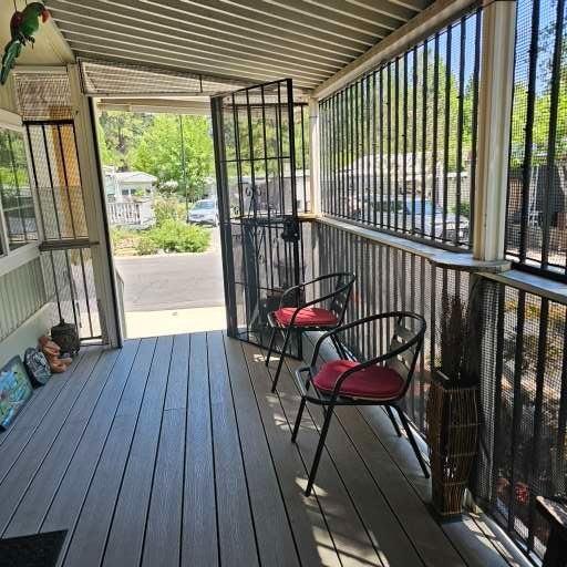 450 Gladycon Road, Unit 32 Colfax, CA 95713 - Photo 27 of 29 a view of a balcony with furniture and wooden floor