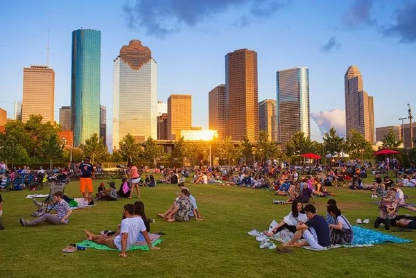 a group of people sitting in back of a of big yard