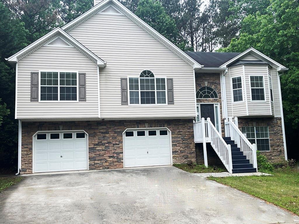 a view of a house with a yard and garage