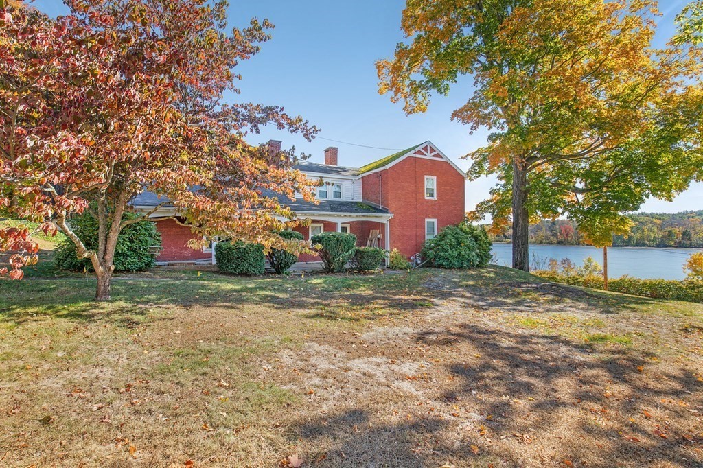 122 River Road Merrimac, MA 01860 - Photo 6 of 28 a view of a yard with a house in the background