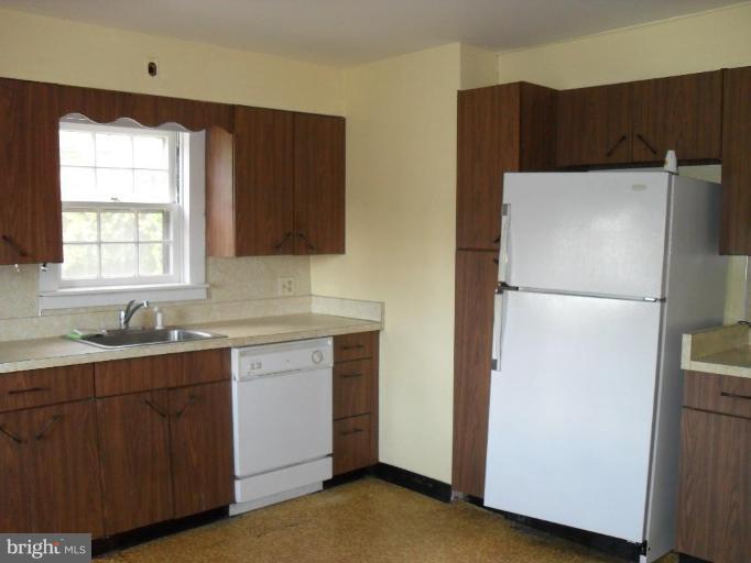 2019 Laurel Brook Road Fallston, MD 21047 - Photo 3 of 14 a kitchen with a refrigerator sink and cabinets