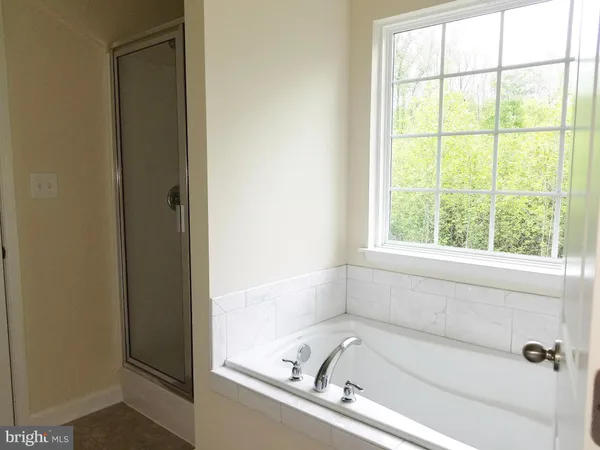 a white bath tub sitting next to a window