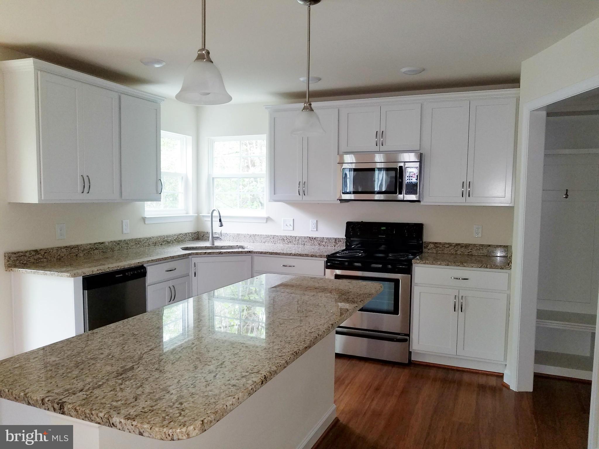 10312 Bluebird Court Spotsylvania, VA 22553 - Photo 5 of 20 a kitchen with stainless steel appliances granite countertop a stove a sink and a microwave