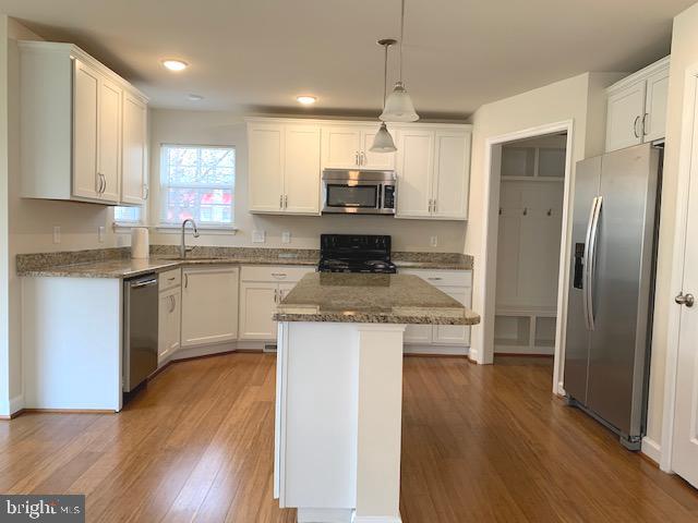 10312 Bluebird Court Spotsylvania, VA 22553 - Photo 7 of 20 a kitchen with stainless steel appliances granite countertop a refrigerator a stove a sink and a microwave