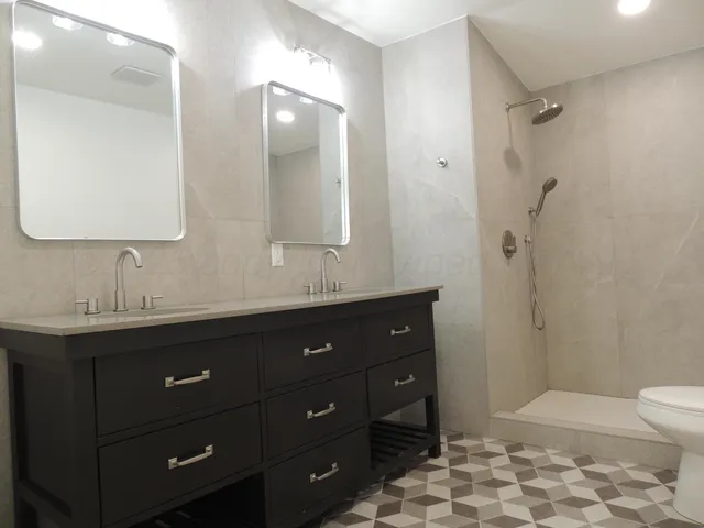 a bathroom with a sink vanity granite and toilet