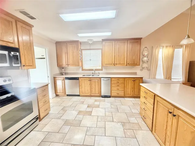 a large kitchen with cabinets and a stove top oven