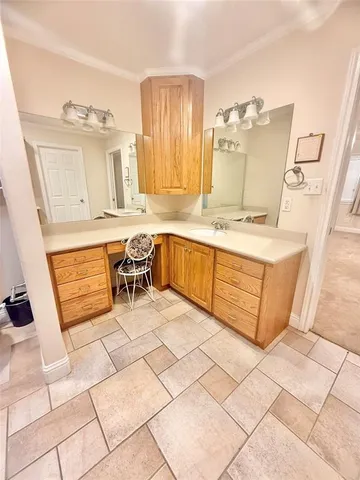 a large white kitchen with a stove a sink and a microwave