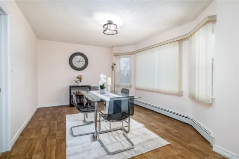 a view of a room that has a table and a chair in it