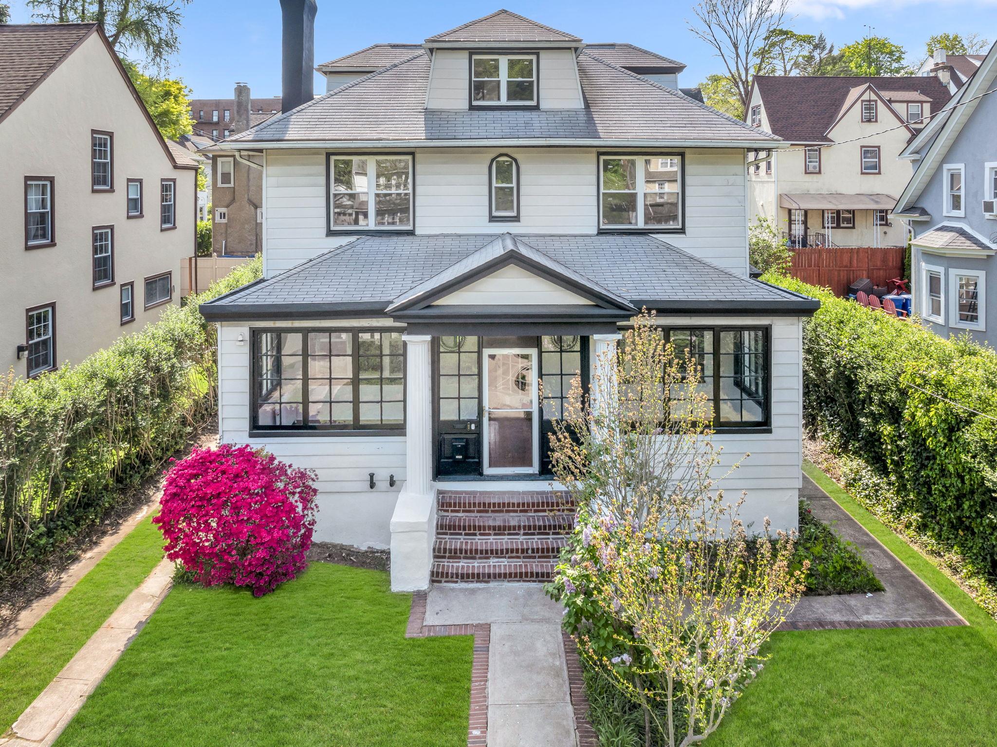 a front view of a house with garden
