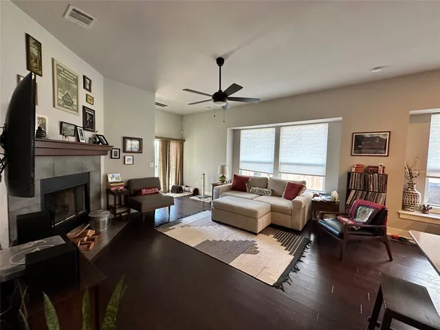 a living room with furniture fireplace and a large window
