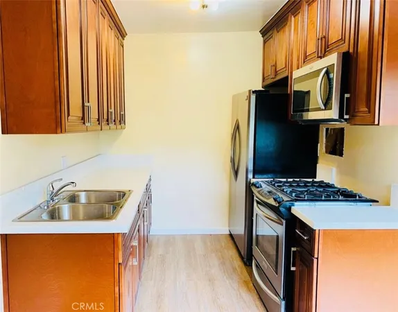 a kitchen that has a sink and a stove