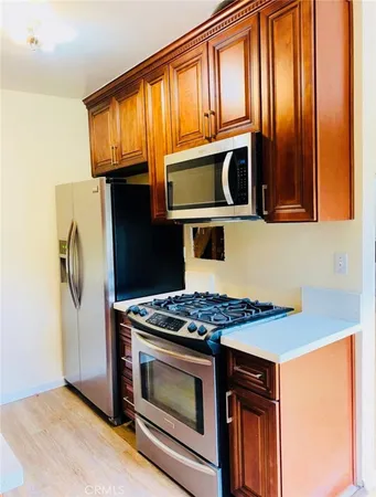 a kitchen with stainless steel appliances granite countertop cabinets and a stove top oven