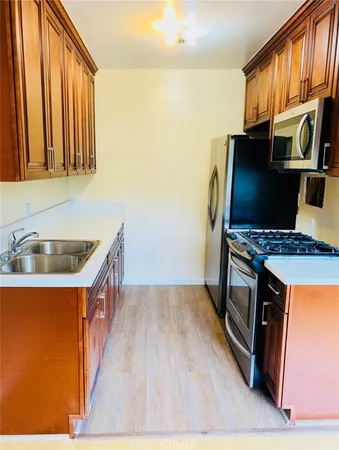 a kitchen that has a microwave a stove and a sink