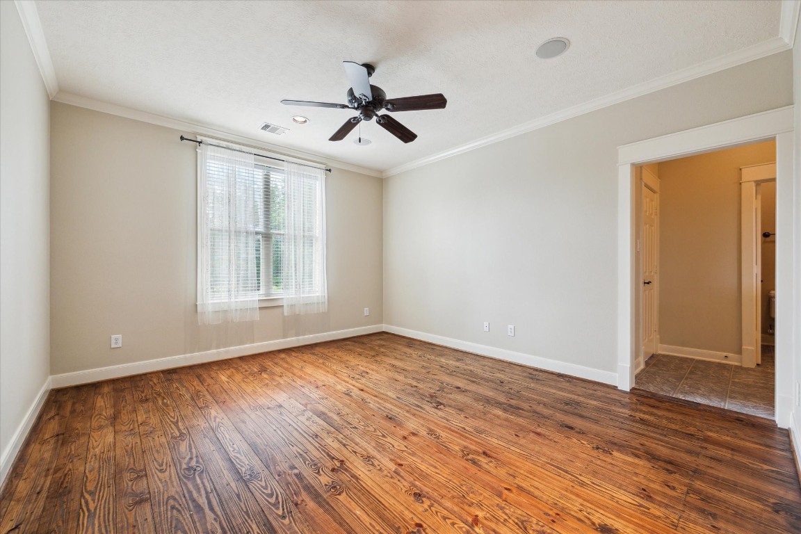 4511 Upper Oxbow Trace Fulshear, TX 77441 - Photo 19 of 40 a view of empty room with wooden floor and fan