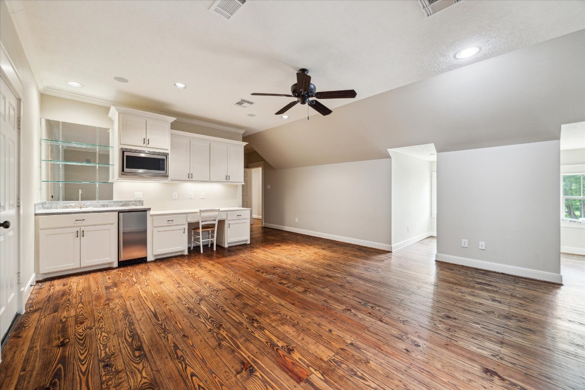 4511 Upper Oxbow Trace Fulshear, TX 77441 - Photo 20 of 40 a view of a kitchen with furniture and a ceiling fan