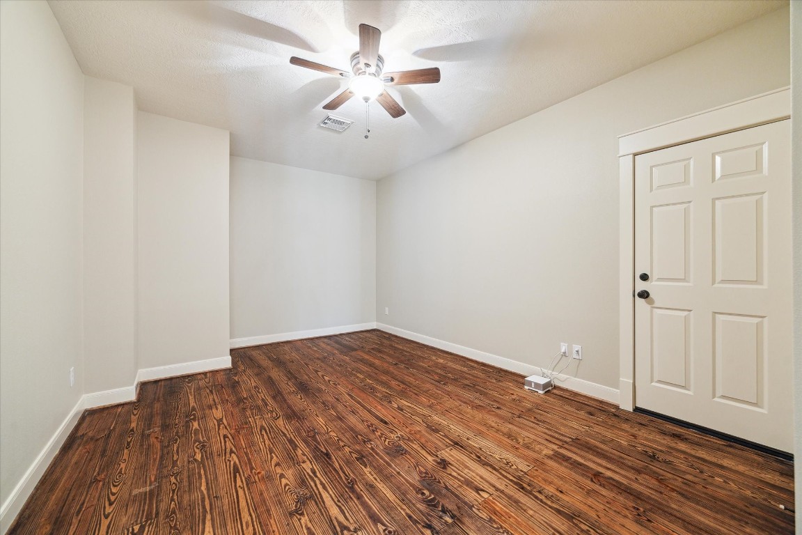 4511 Upper Oxbow Trace Fulshear, TX 77441 - Photo 22 of 40 an empty room with wooden floor and windows