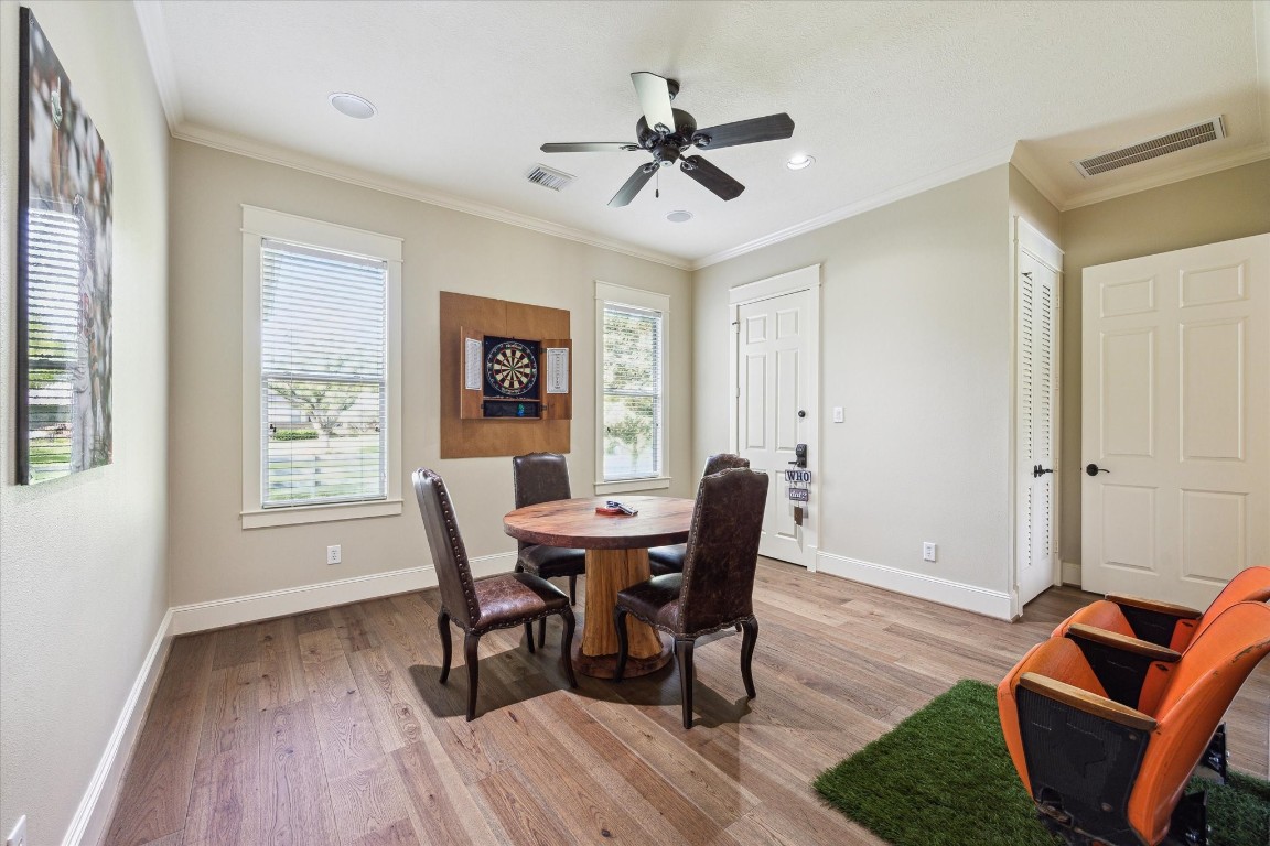 4511 Upper Oxbow Trace Fulshear, TX 77441 - Photo 31 of 40 a view of a dining room with furniture window and wooden floor