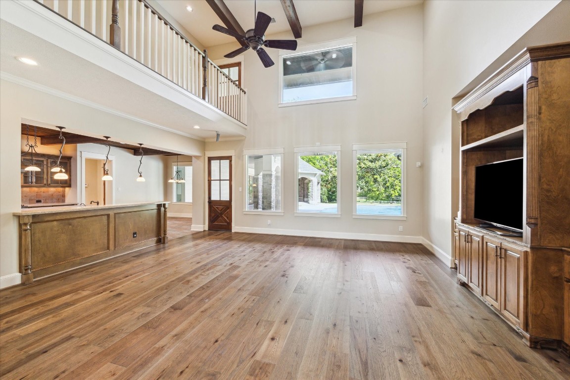 4511 Upper Oxbow Trace Fulshear, TX 77441 - Photo 7 of 40 wooden floor in an empty room with a window and wooden floor