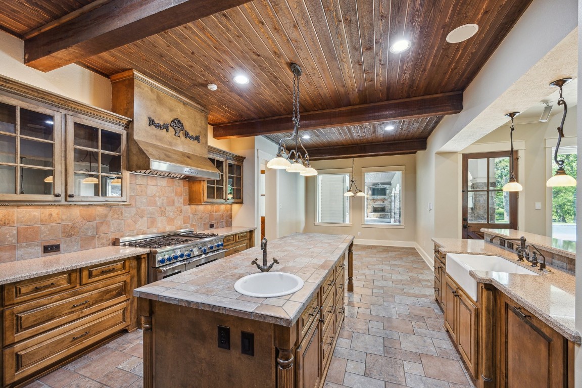 4511 Upper Oxbow Trace Fulshear, TX 77441 - Photo 10 of 40 a kitchen with sink stove and cabinets