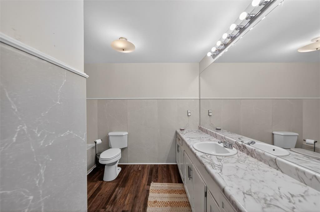 23363 Wateridge Loop Flint, TX 75762 - Photo 33 of 40 a bathroom with a granite countertop sink a toilet and a mirror