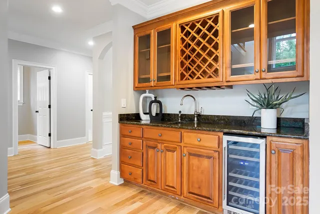 a view of kitchen with sink and refrigerator