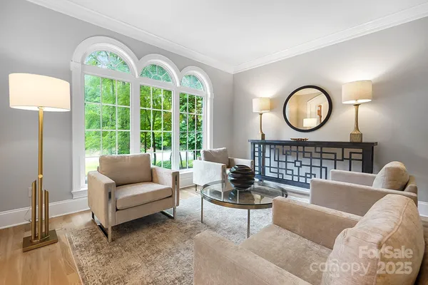 a living room with furniture a fireplace and a large window