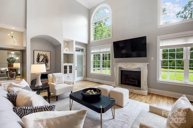 a living room with furniture and floor to ceiling window
