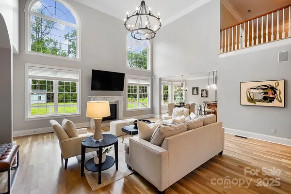 a living room with furniture a flat screen tv and a dining table