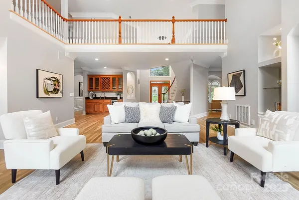 a living room with furniture a rug and a window