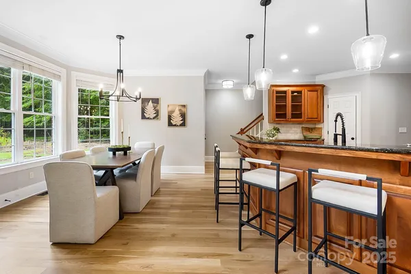 a dining table chairs and a chandelier