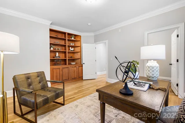 a view of a room with wooden floor and windows