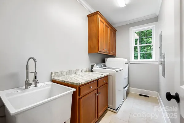 a utility room with a sink washer and dryer