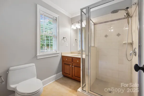 a bathroom with a toilet a sink and shower