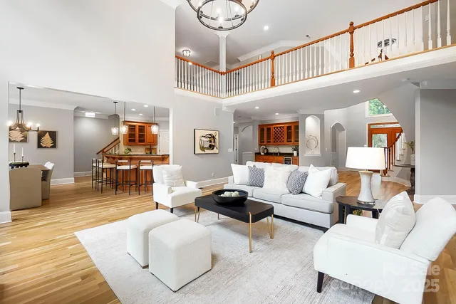 a living room with fireplace furniture and a large window