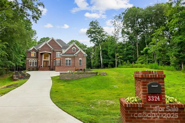 a front view of a house with yard and green space