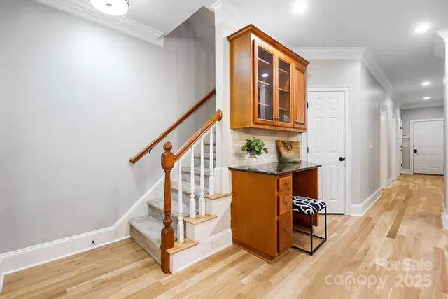 a living room with furniture a fireplace and a large window