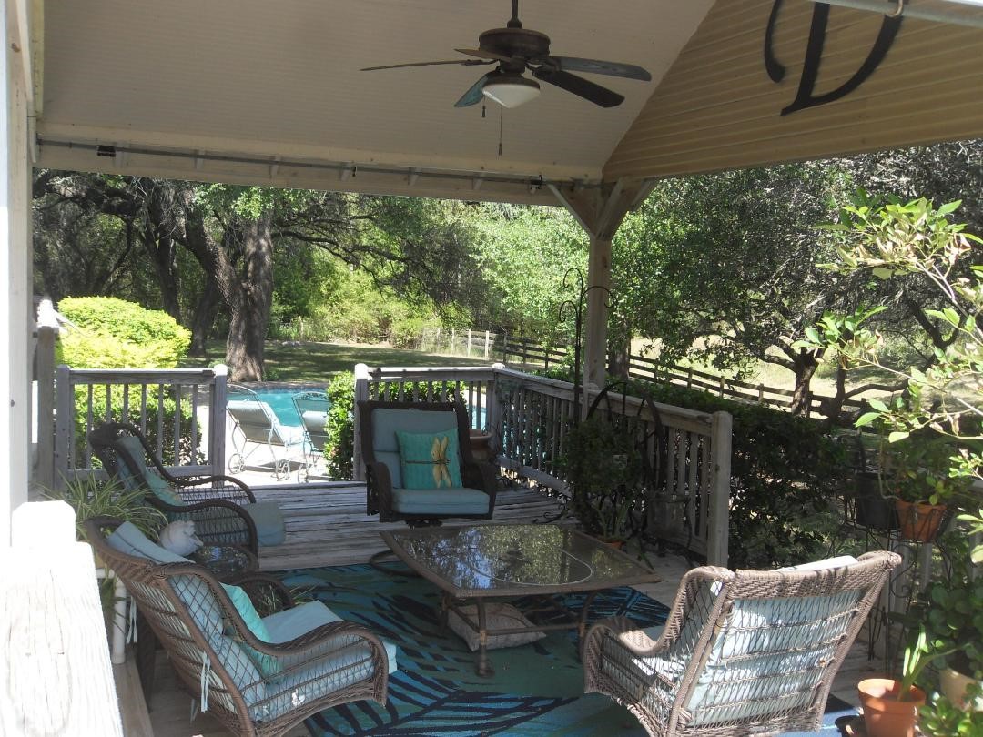 8456 Schuster Road Ledbetter, TX 78946 - Photo 38 of 49 a view of a patio with table and chairs potted plants and large tree