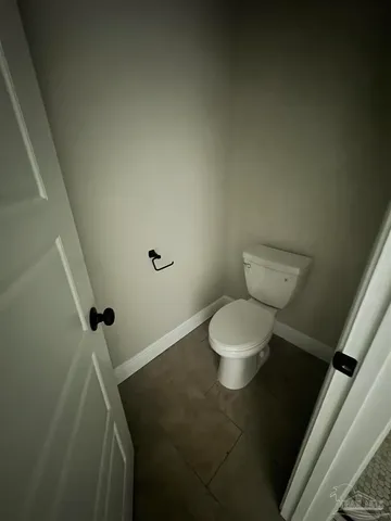 a white toilet sitting next to a bathroom sink