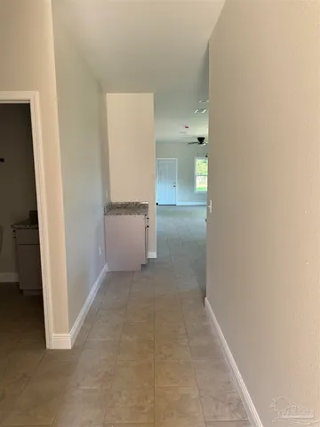 an empty room with an entrance to other room