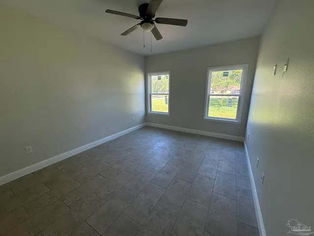 a view of room window and a ceiling fan