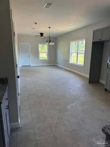 a view of an empty room with a window