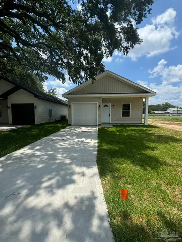 a front view of house with yard and green space