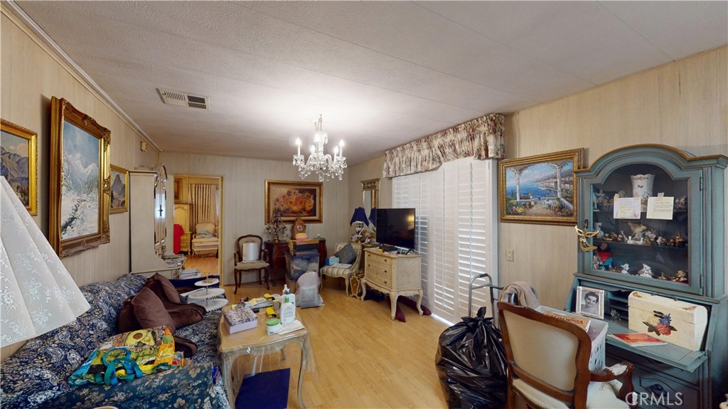 14851 Jeffrey Road, Unit 117 Irvine, CA 92618 - Photo 22 of 45 a living room with furniture a chandelier and a fireplace