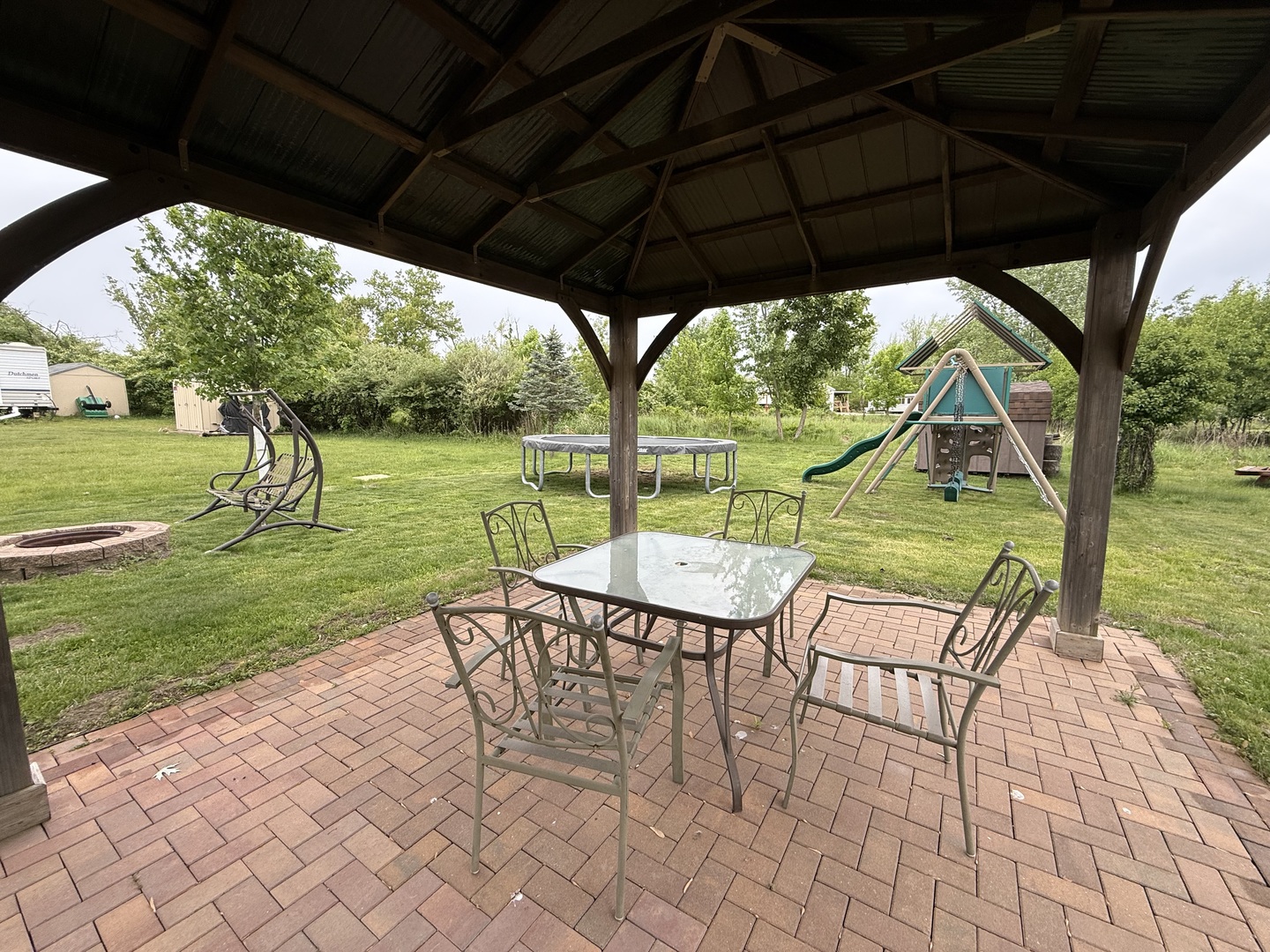 22-22 Woodhaven Lakes Sublette, IL 61367 - Photo 13 of 15 a view of yard with table and chairs under an umbrella