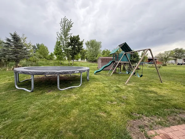 a view of a backyard with table and chairs