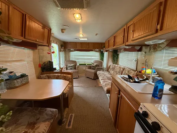 a kitchen with sink a stove and chairs