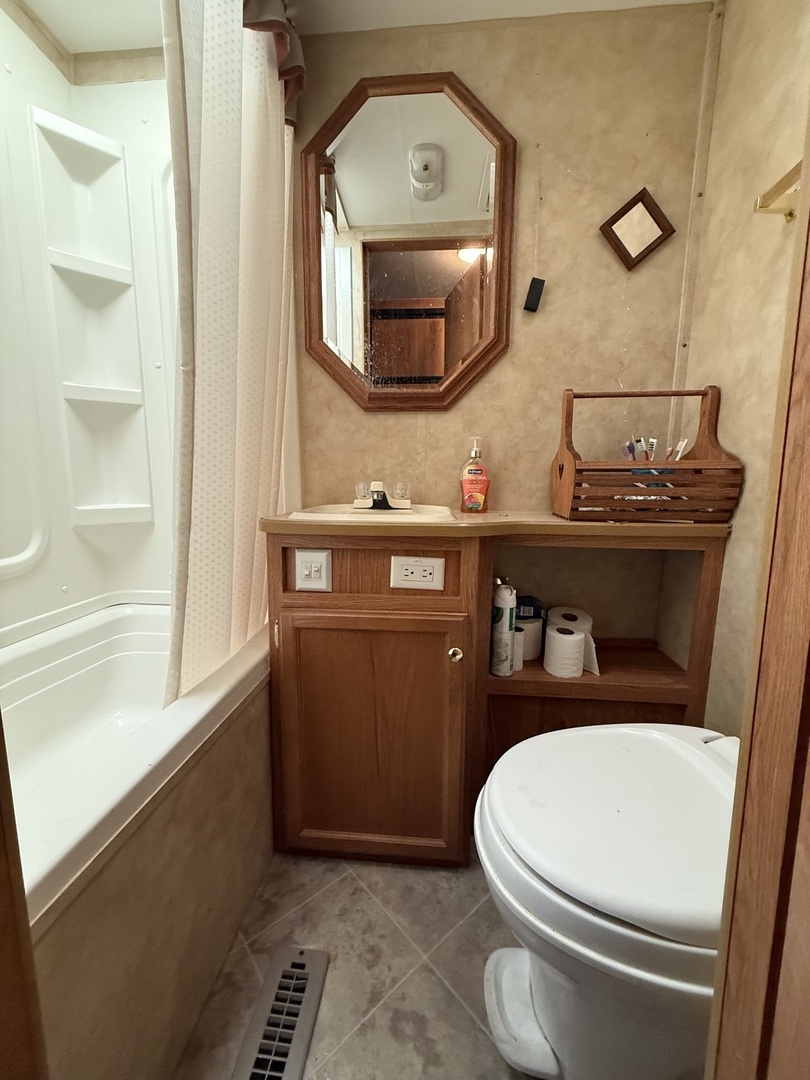 22-22 Woodhaven Lakes Sublette, IL 61367 - Photo 9 of 15 a bathroom with a toilet a sink and mirror