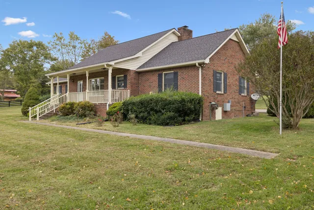 an empty room with furniture and chandelier fan